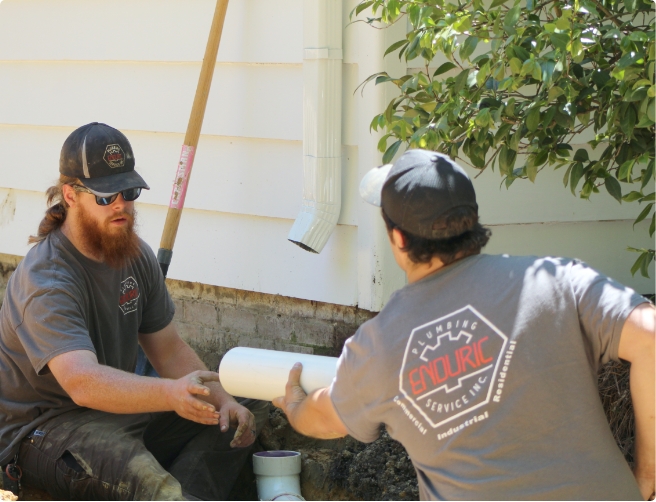 plumbing technicians replacing a pipe