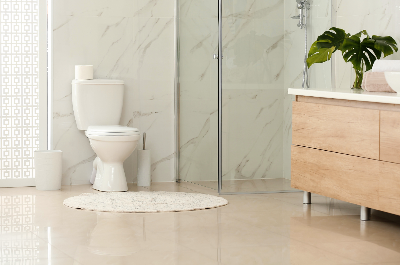 Beautiful modern bathroom with a glass shower and porcelain toilet